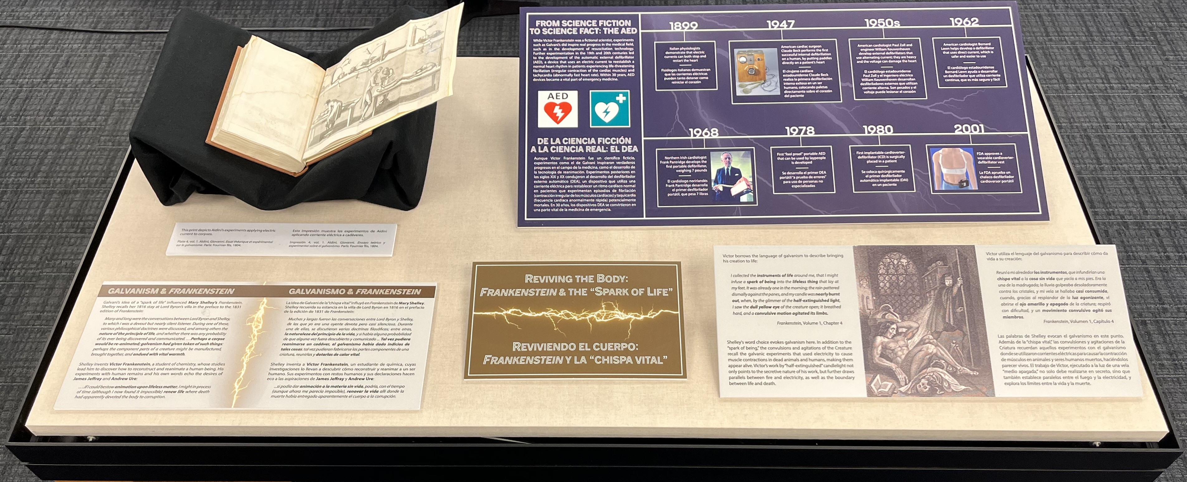 exhibit case with text and images and books about reviving the body