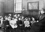 Children attend a music class at Chicago's Hull House, ca. 1921. Via Internet Archive.