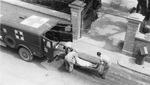 Unloading ambulance in front of x-ray department, Ain el-Turck, 1943. Via Galter Special Collections.