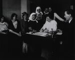 Immigrant piecing together a wooden puzzle as part of an examination, early 1900s. Via the National Library of Medicine.