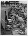 Shelter-tent pitching drill, Fort Custer, 1942. Via Galter Special Collections.