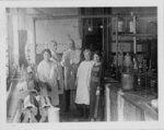 Reba Haner (left) and four unidentified individuals, likely in Arthur Kendall’s lab, c. 1920-24. (Arthur Kendall presentation album, 2016.15.0020). Via Galter Special Collections.