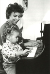 Cheryl Woodson with daughter Lauren, Ward Rounds, Summer 1996. Via Galter Special Collections.