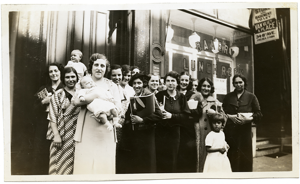 A group of women and children standing outside of the Henry Street Visiting Nursing Service circ 1932